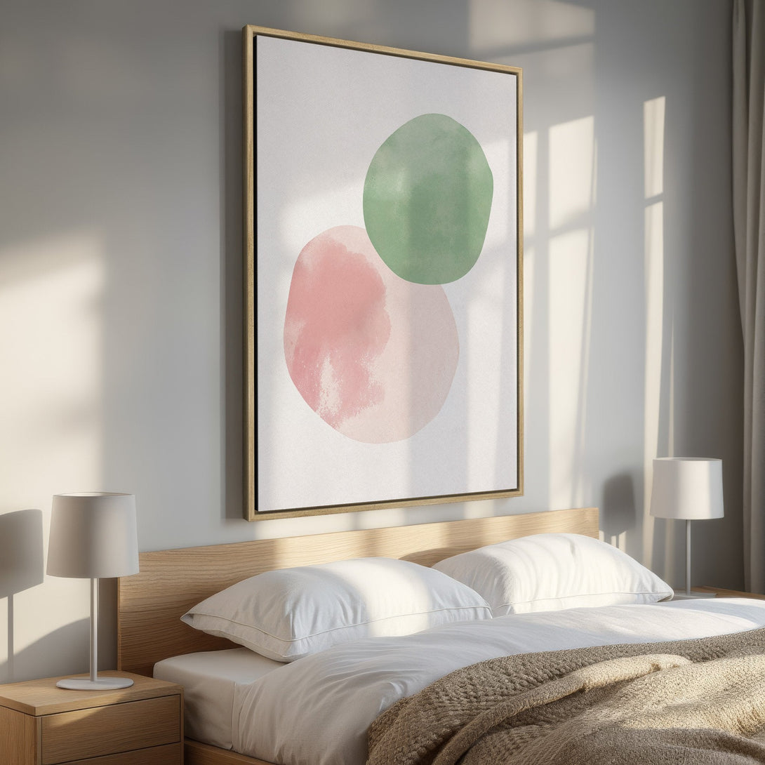 Framed Wall Art: Abstract art Canvas Print with pink & green watercolor circles. Modern bedroom decor with neutral color palette and natural light.