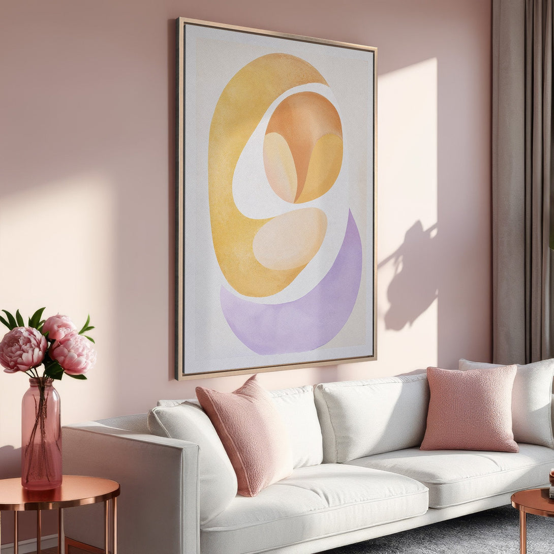 Framed Wall Art featuring an abstract design in soft yellow, orange, and purple hues. Modern art for a stylish living room.