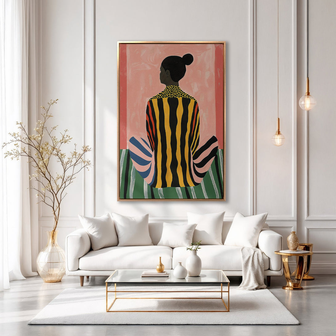 Framed Wall Art featuring a seated figure in colorful stripes, displayed in a stylish, modern living room with a neutral color palette. Elevate your space!