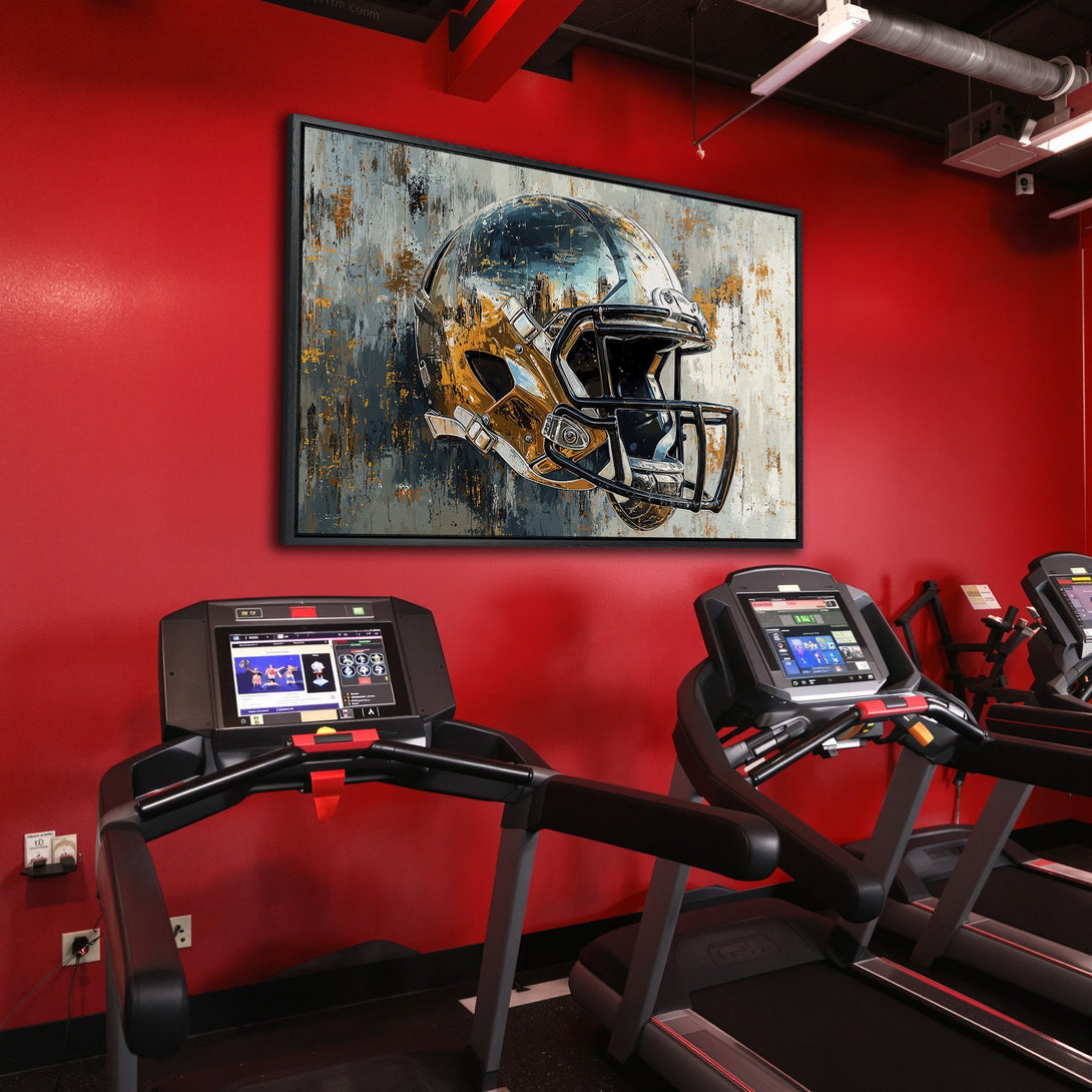 Framed Wall Art featuring a gold football helmet in an abstract style. Neutral & gold tones pop against a red wall, perfect for sports fans!