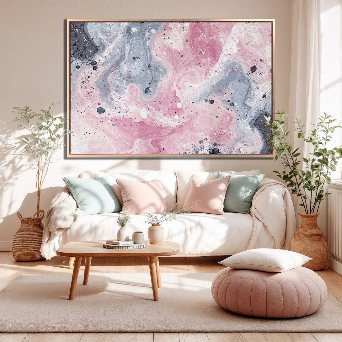 Framed Wall Art: Abstract pink & gray canvas print adds modern elegance to a living room. Enhance your space with this beautiful artwork!