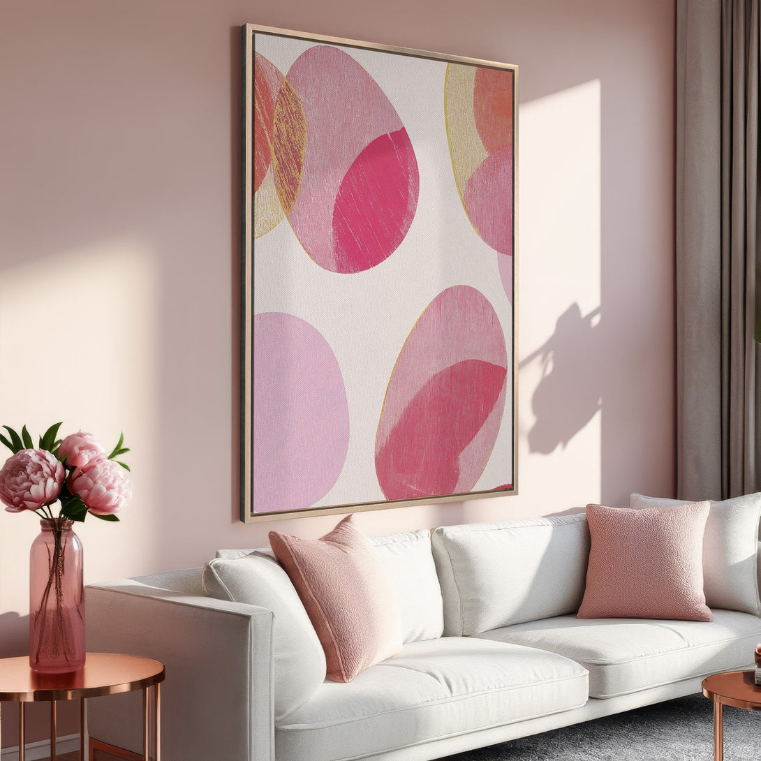 Framed Wall Art featuring abstract pink circles, adding a pop of color to a modern living room. Soft pink and gold palette, perfect for a stylish home.