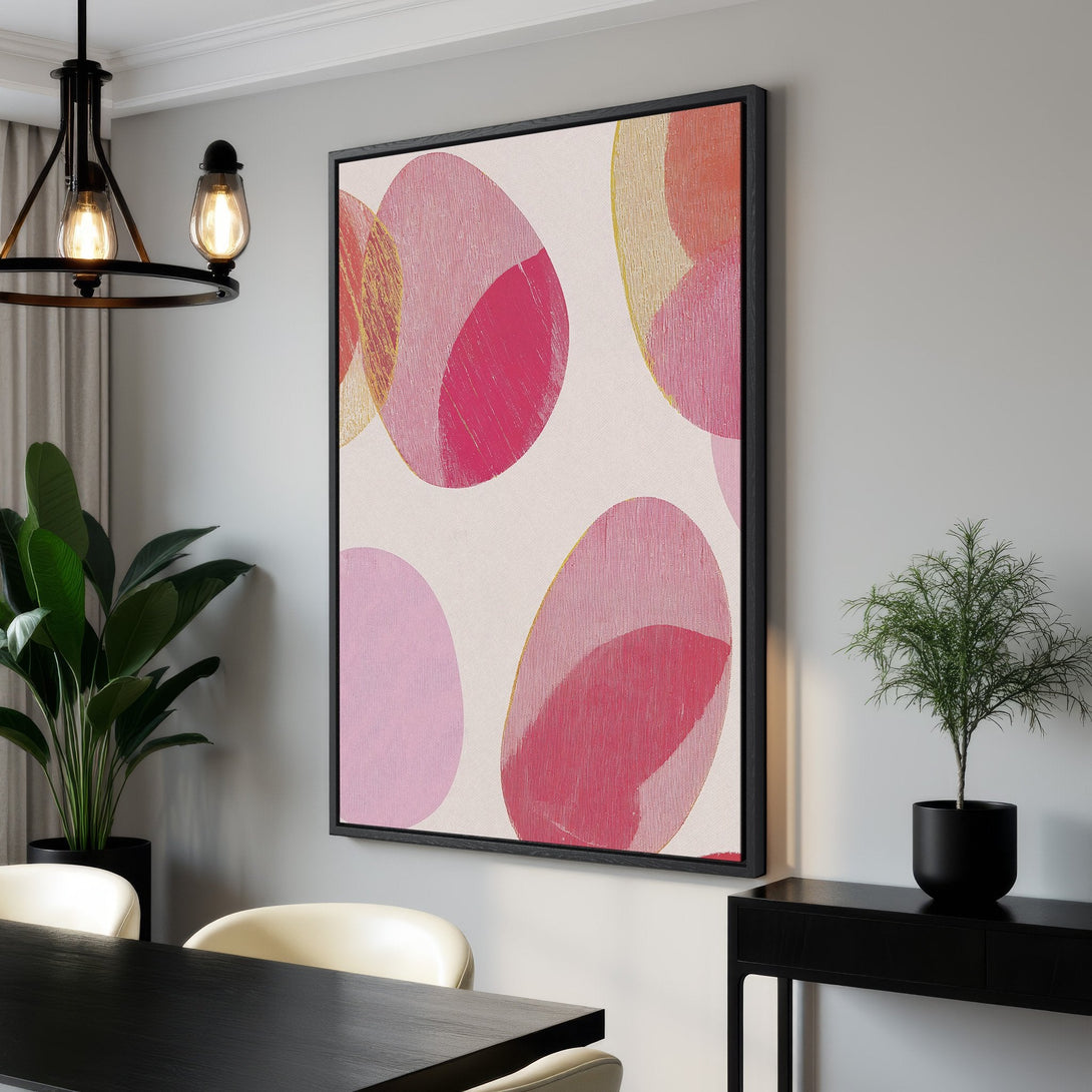 Framed Wall Art featuring abstract pink and gold circles. Modern art canvas print in a dining room, adding a pop of color and style to any space.
