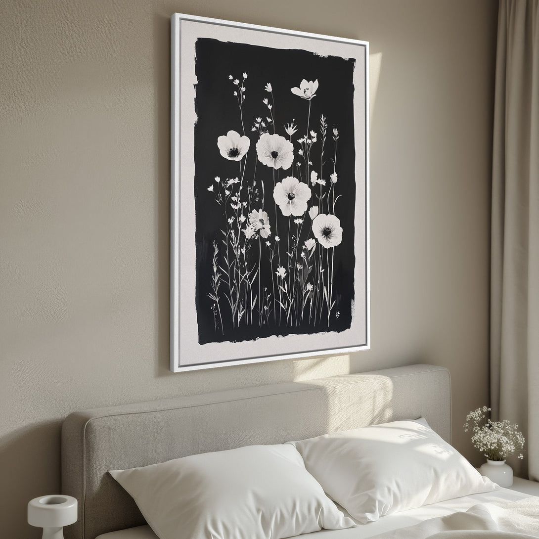 Framed Wall Art featuring a black and white floral design. Modern, minimalist style in a bedroom setting. Perfect for adding a touch of elegance.