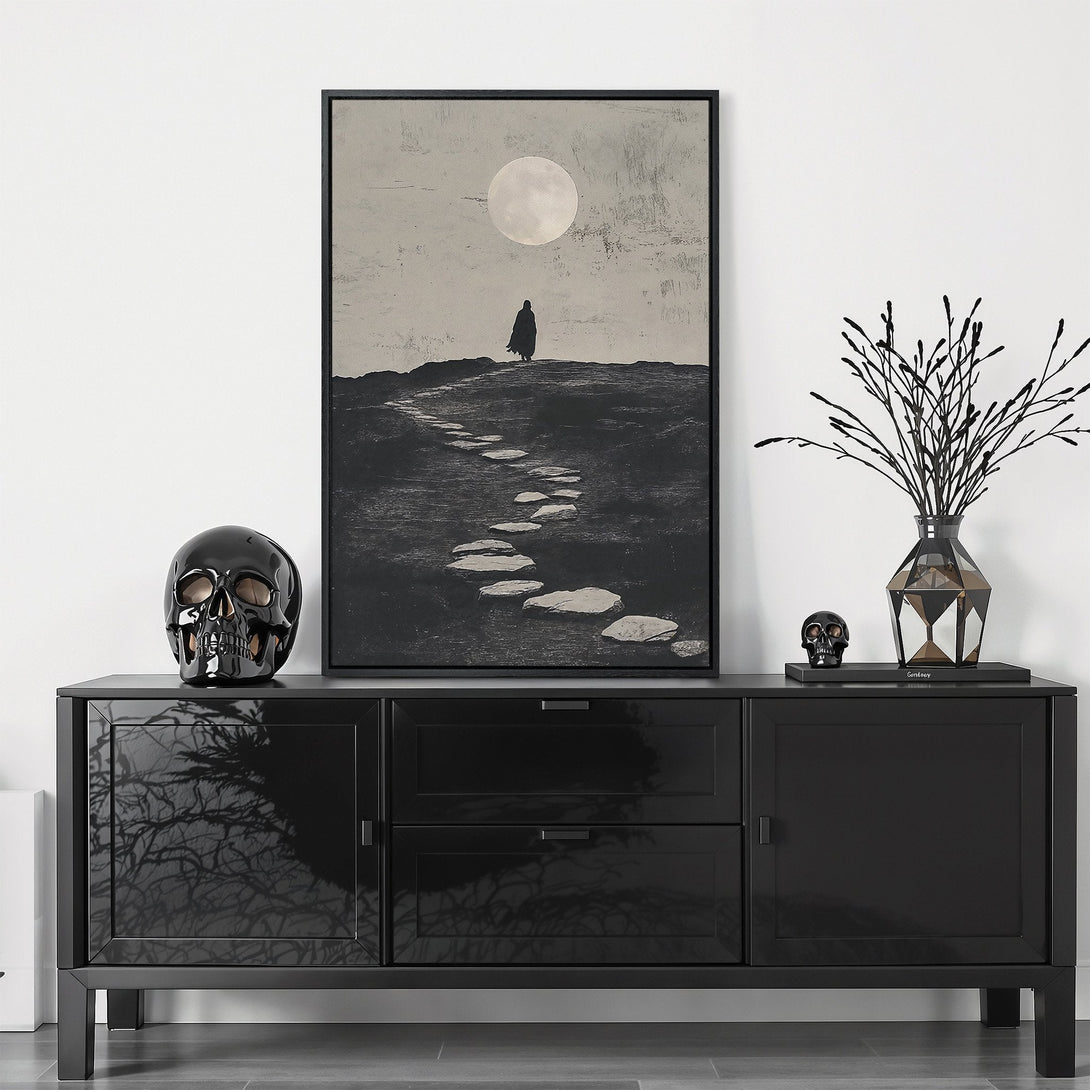 Framed Wall Art featuring a silhouetted figure under a moon. Modern, minimalist style with a monochromatic black and white color palette. Perfect for home decor.