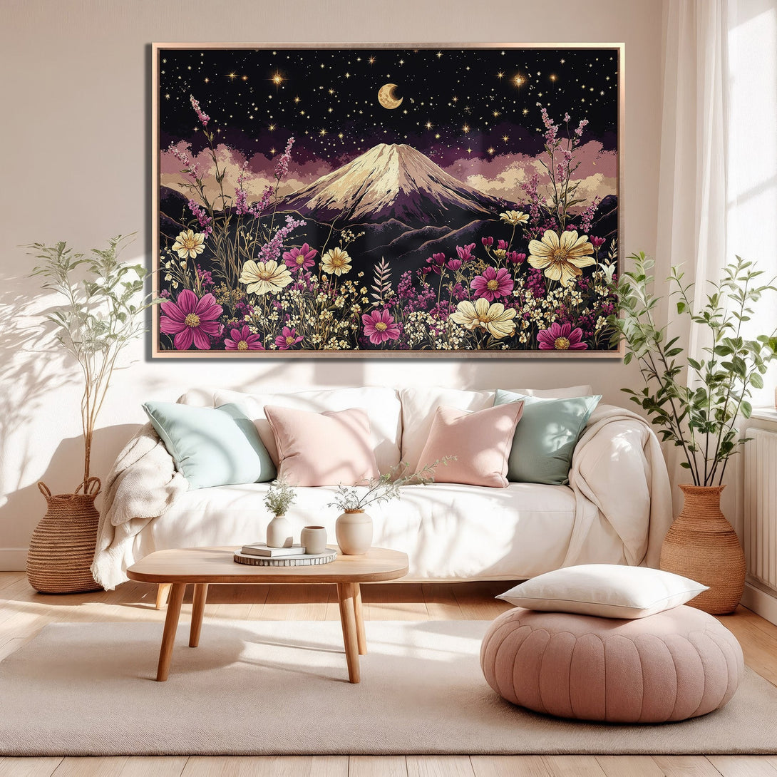 Framed Wall Art: Mountain landscape Canvas Print in a cozy living room. Features a night sky, flowers, and a purple, pink, and gold color palette.