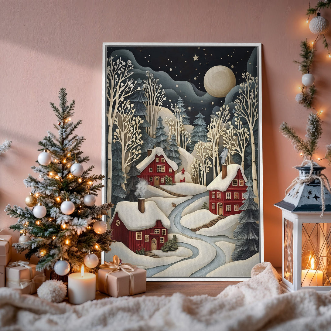 Framed Wall Art of a winter village scene with red houses, snowy landscape, and a dark blue night sky. Cozy, inviting, and perfect for holiday decor.