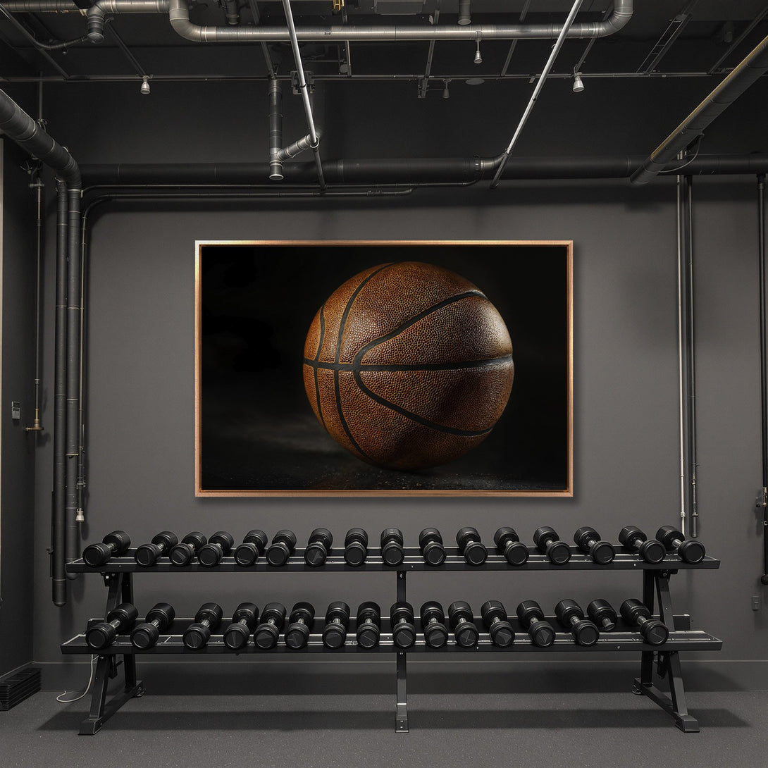 Framed Wall Art featuring a detailed basketball in a moody, industrial interior. Warm brown tones pop against a cool gray palette. Elevate your space!
