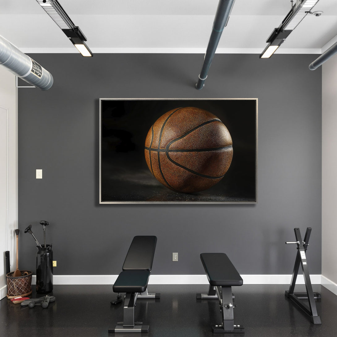 Framed Wall Art featuring a detailed basketball in a gym setting. Warm brown tones against a dark gray backdrop. Elevate your space with sports art!