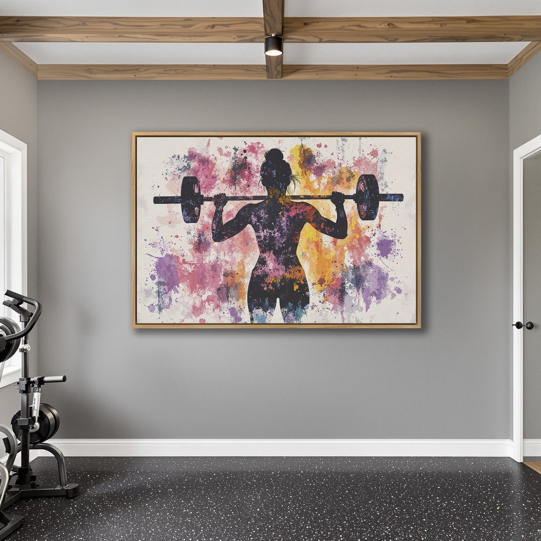 Framed Wall Art of a weightlifting woman in a watercolor style with a vibrant pink, purple, and yellow color palette, perfect for gym decor.