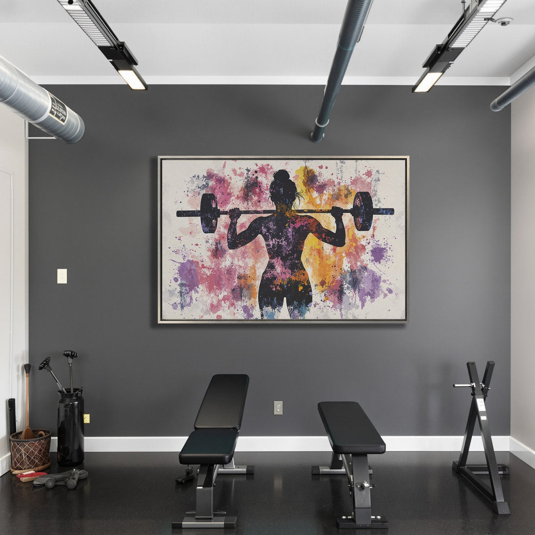 Framed Wall Art: Watercolor silhouette of a woman lifting weights. Colorful abstract splashes. Perfect for gym decor.