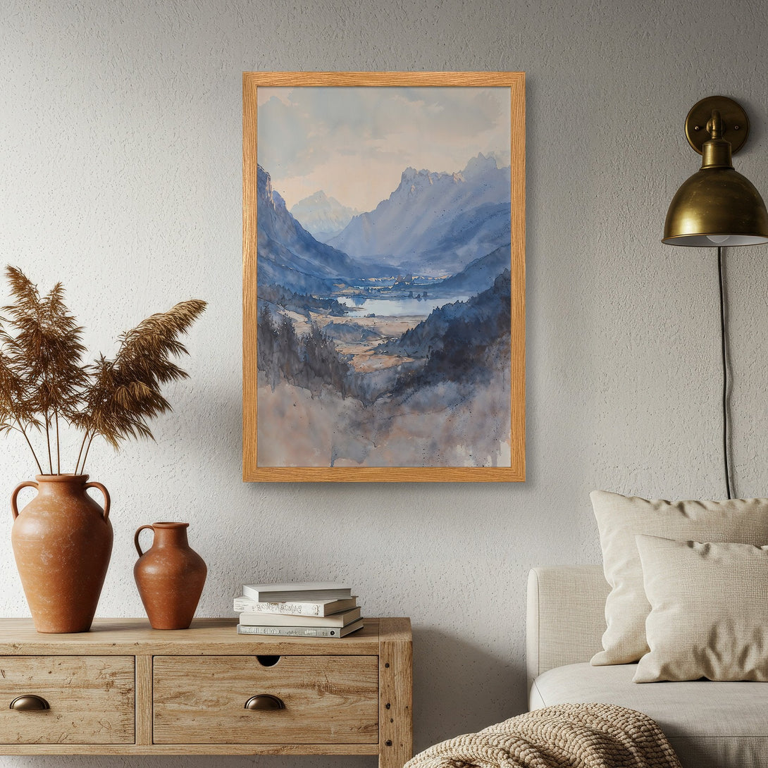 Framed Poster featuring a watercolor landscape of mountains and a lake, with a cool blue and neutral color palette. Perfect wall art!