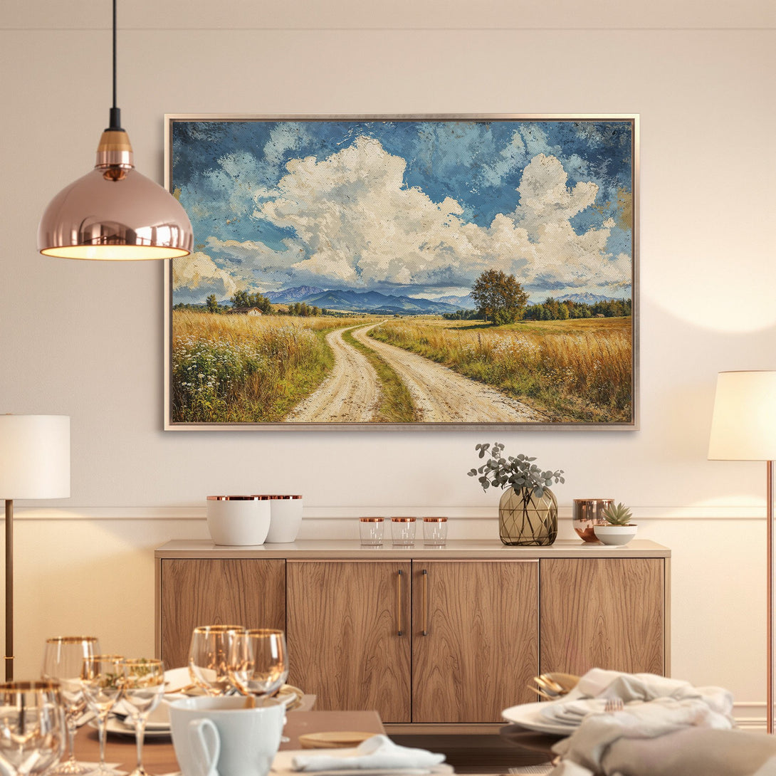 Framed Wall Art: Landscape painting with a dirt road, blue sky, and golden fields. Rustic style, warm color palette. Perfect home decor.