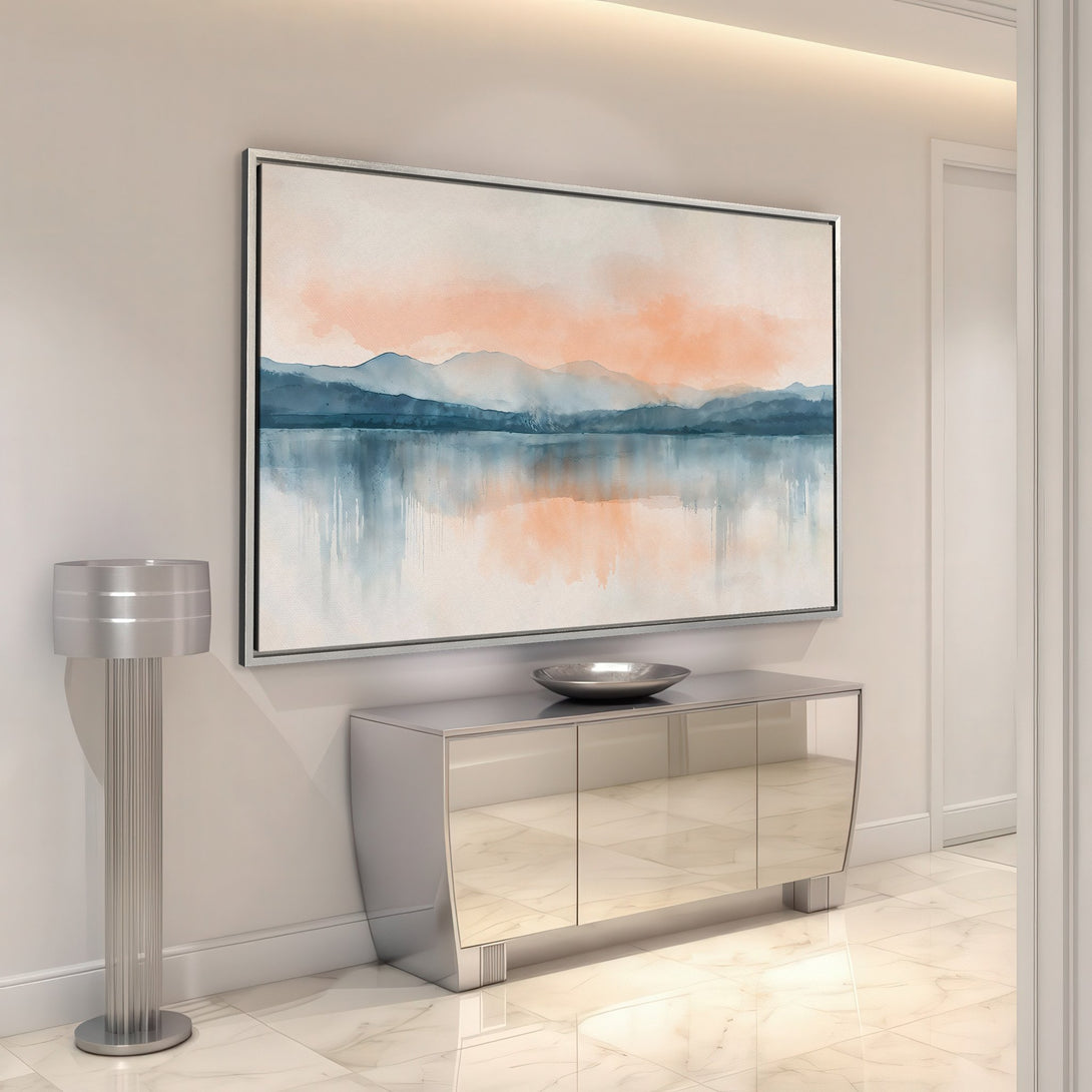 Framed Wall Art featuring a serene watercolor landscape in blue and peach hues. Perfect for adding a touch of calm to any space.