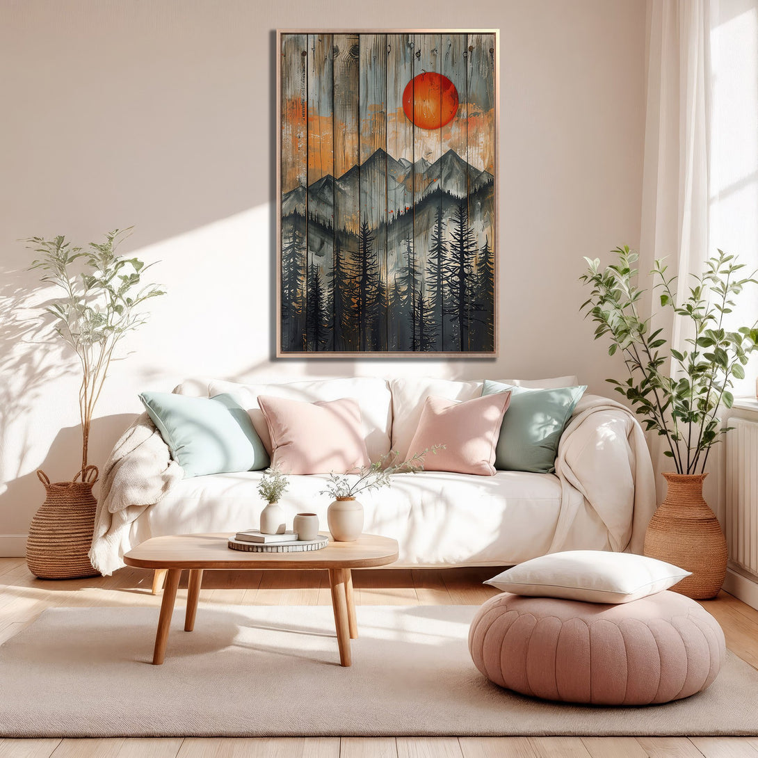 Framed Wall Art: Rustic mountain scene with a vibrant orange sun. Earthy tones and a cozy interior setting. Perfect for adding warmth to your home decor.