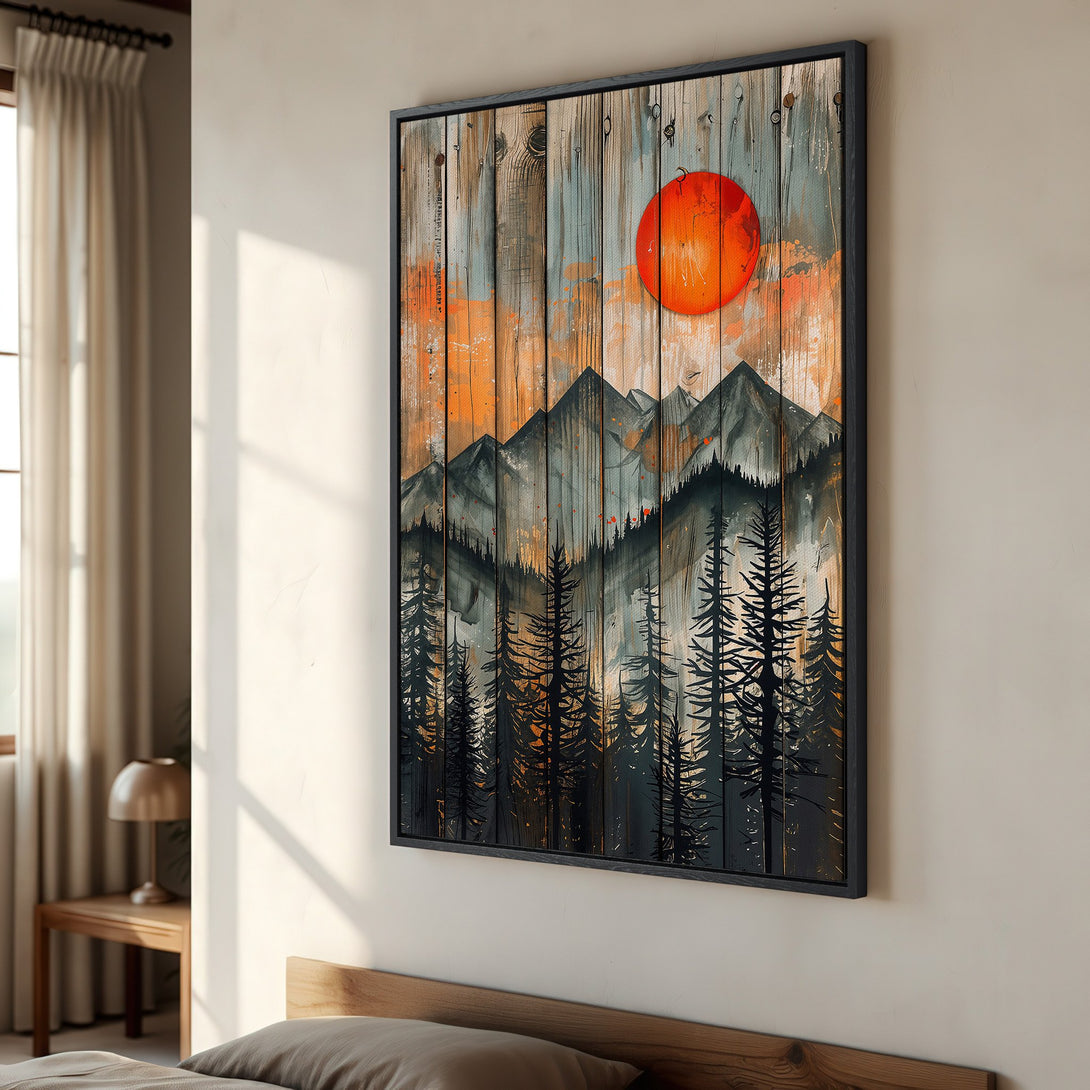 Framed Wall Art: Mountain landscape Canvas Print with a rustic style, featuring a vibrant orange sun and a palette of black, gray, and orange hues.