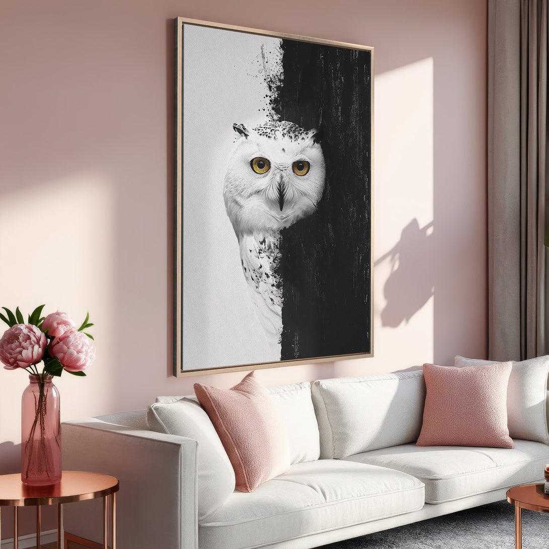 Framed Wall Art featuring a stunning black and white owl with golden eyes. Modern style, perfect for adding a touch of elegance to any interior. Soft pink color palette.