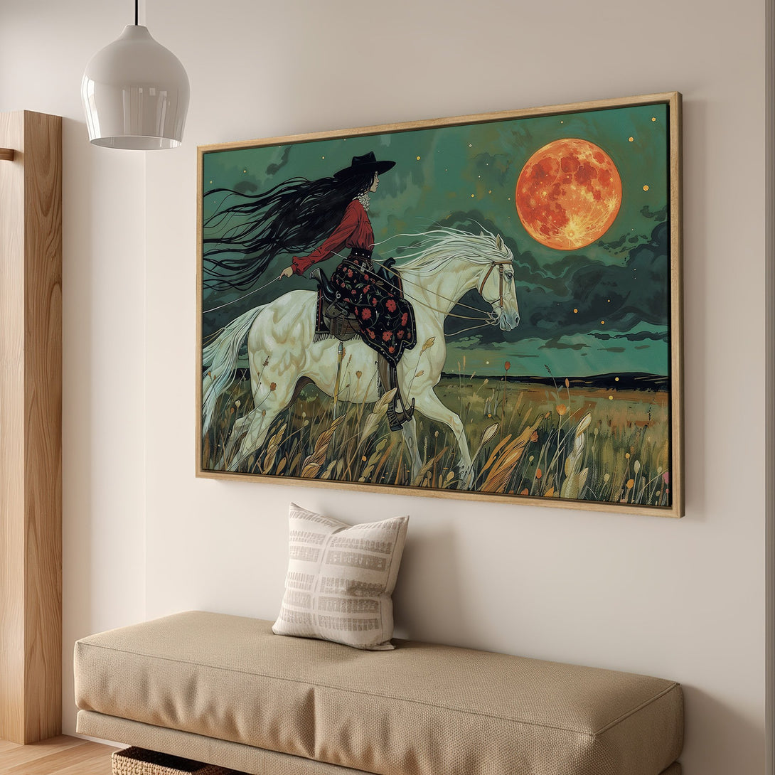 Framed Wall Art: Stunning illustration of a woman riding a white horse under a red moon. Moody teal, orange, and earth tones. Perfect wall decor.