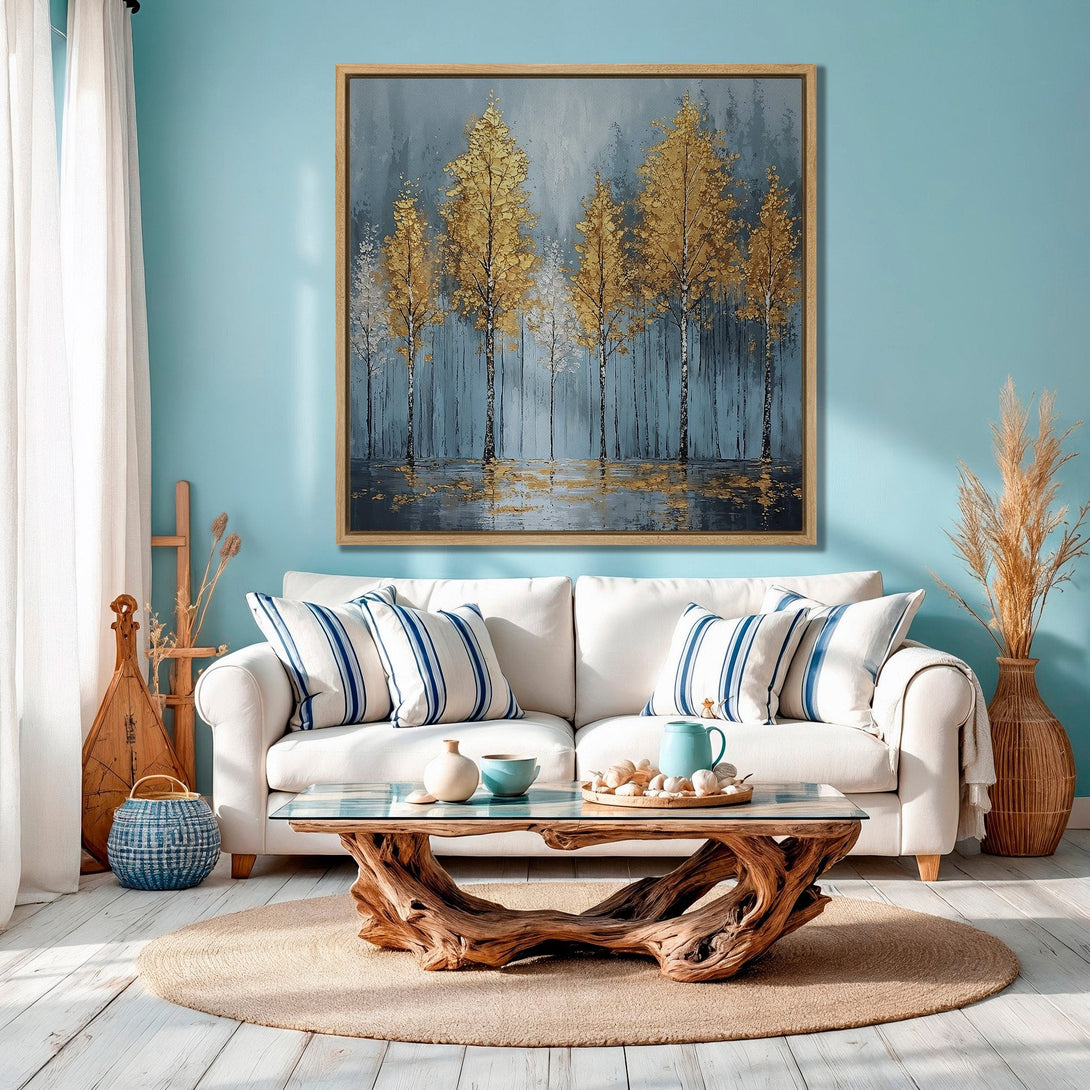 Framed Wall Art: Abstract gold trees painting in a modern living room. Features a calming blue and gold color palette, perfect for adding elegance to your space.