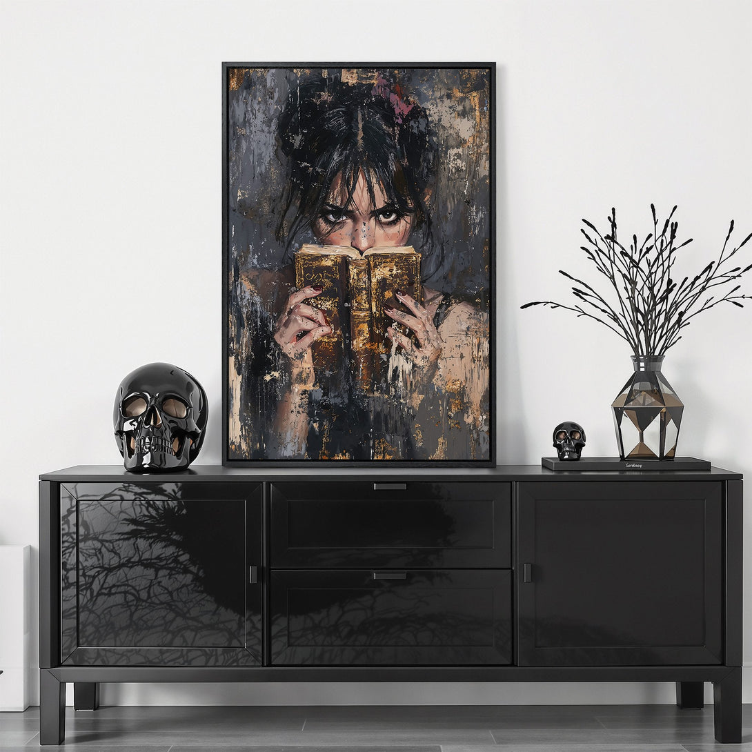 Framed Wall Art featuring a woman reading, with a dark, moody palette of blacks, grays, and gold. Perfect for adding a touch of mystery to your home.