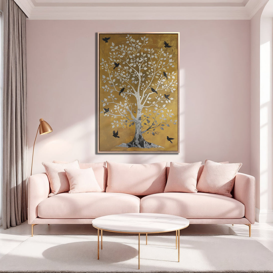 Framed Wall Art featuring a gold and silver tree with birds, displayed in a blush pink living room. Modern, elegant decor with a warm color palette.
