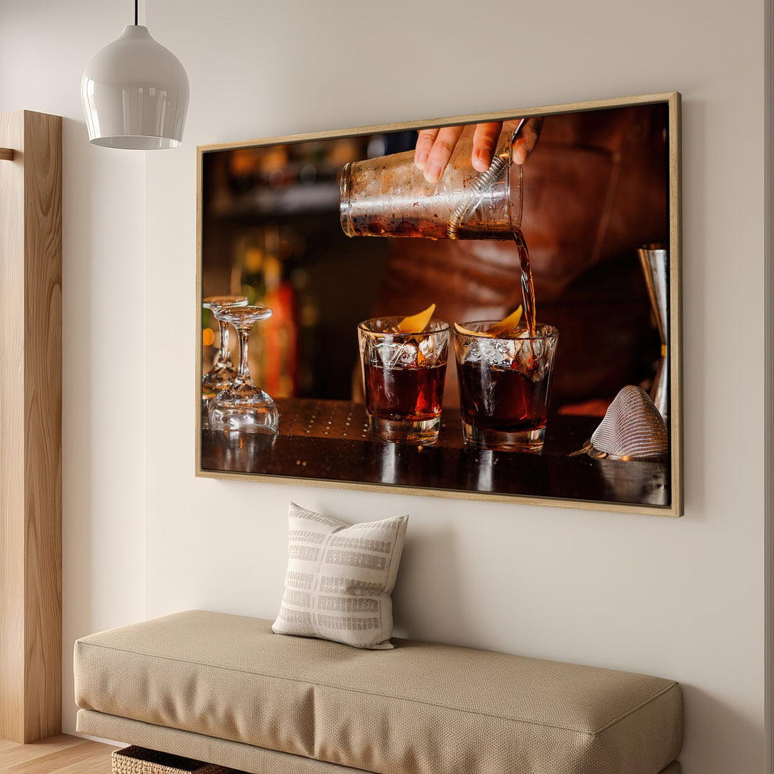Framed Wall Art: Cocktail being poured. Warm, inviting colors in a bar setting. Perfect for kitchen or dining room decor. Shop now!