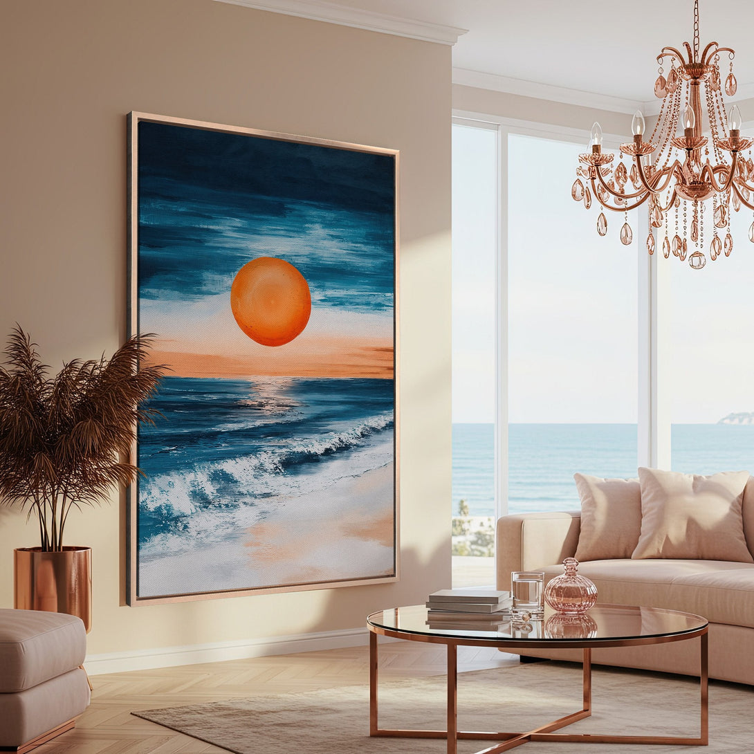 Framed Wall Art: Abstract ocean sunset canvas print in blue, orange, and white. Modern art for coastal decor, displayed in a stylish living room.
