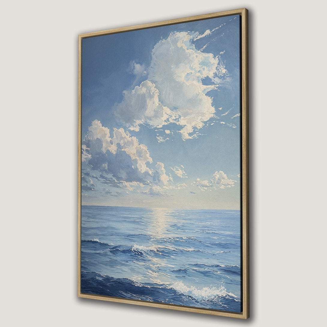 Framed Wall Art: Ocean landscape Canvas Print in blue and white, featuring a serene seascape with clouds and waves. Perfect for coastal decor.