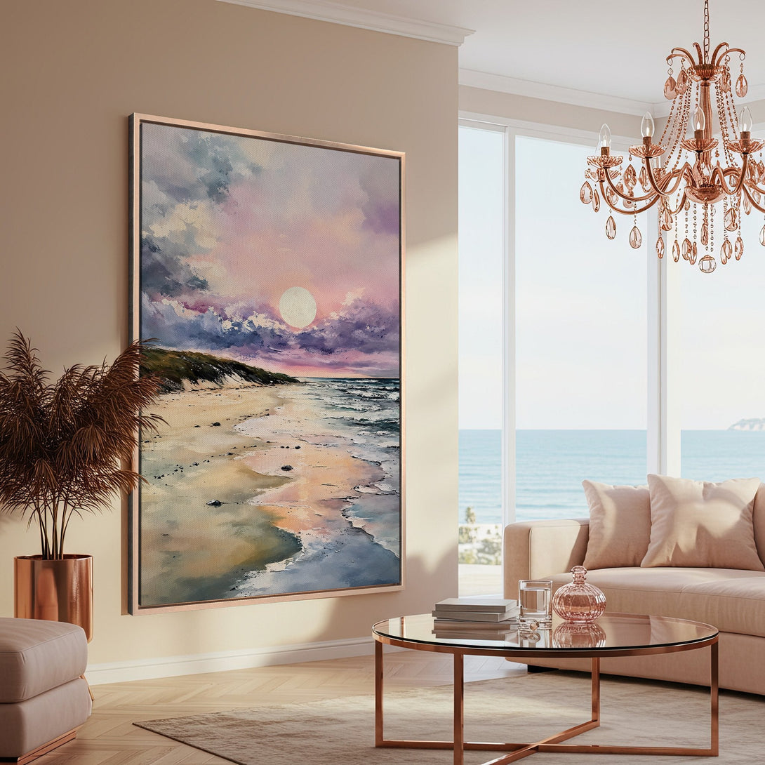 Framed Wall Art: Beach scene canvas print with sunset in a modern living room. Features a pastel color palette of pinks, blues, and beige. Perfect coastal decor.
