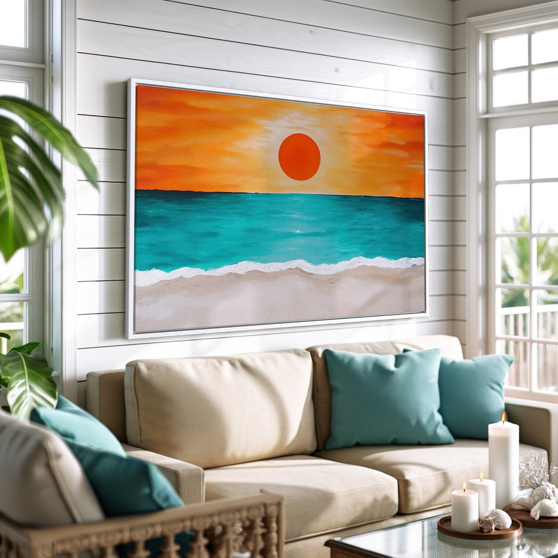 Framed Wall Art featuring a beach sunset in orange and teal. Coastal style canvas print adds a pop of color to a living room.