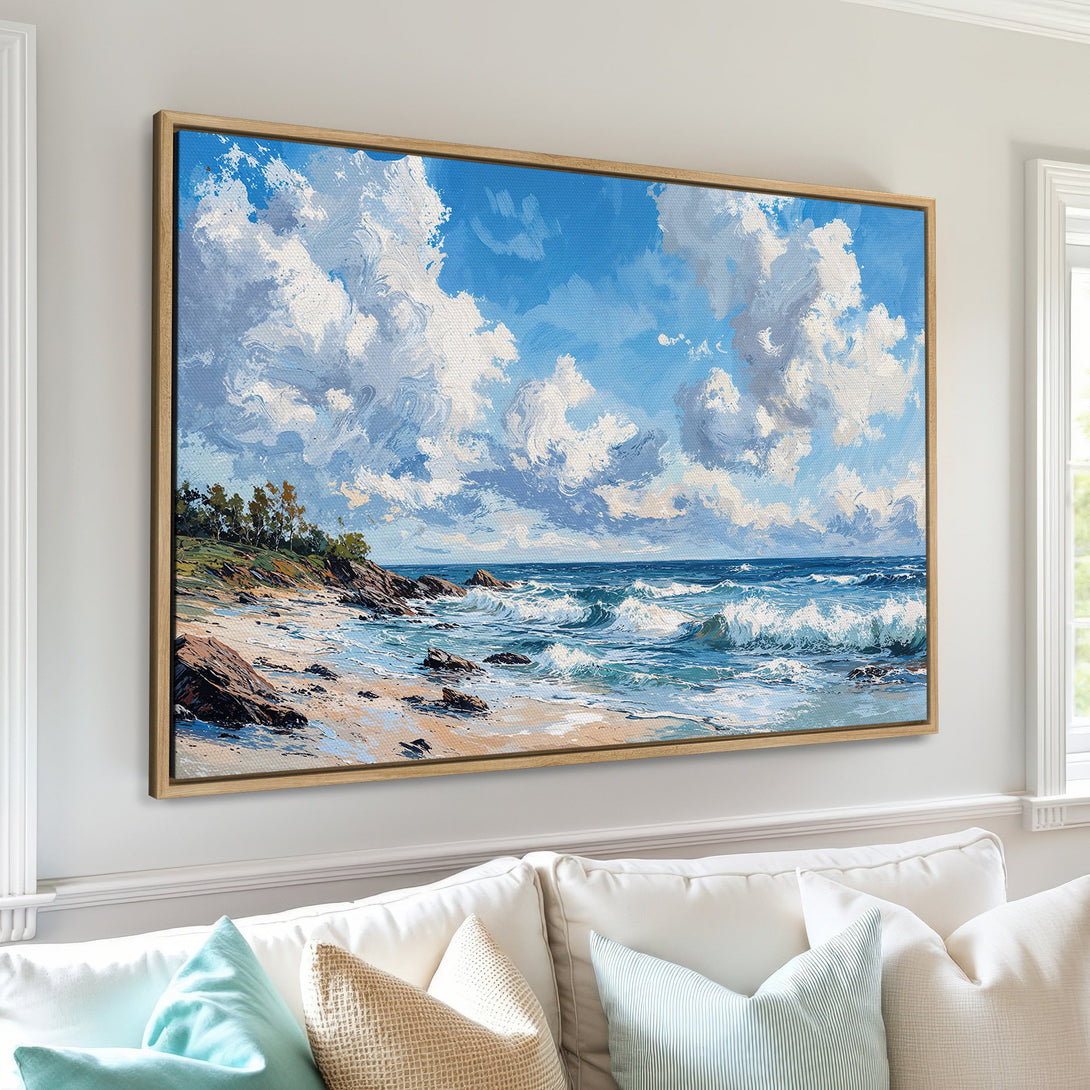 Framed Wall Art of a coastal landscape with blue sky, white clouds, and ocean waves. Impressionistic style with a calming blue and neutral color palette.
