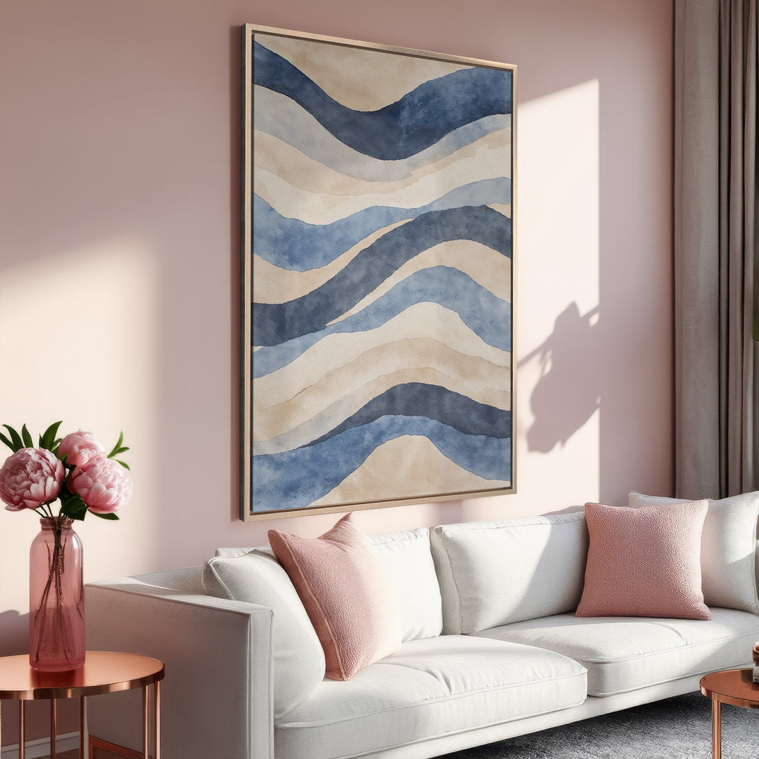 Framed Wall Art featuring abstract watercolor waves in blue and beige hues. Modern art for living room decor, complementing a blush pink interior.