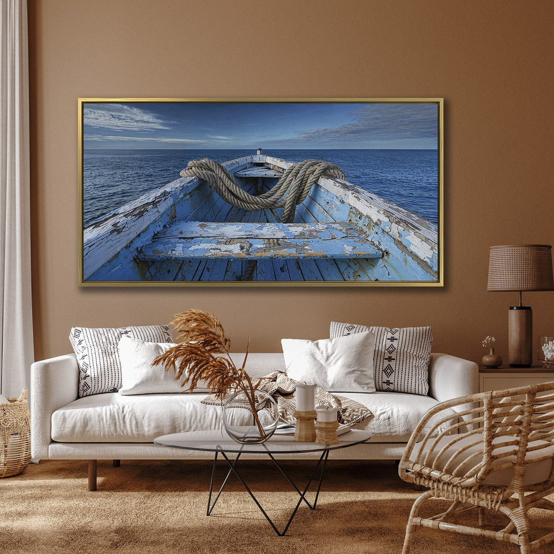 Canvas Print of a weathered blue boat sailing on the ocean. Coastal art with a blue and white color palette, perfect for adding a touch of serenity.