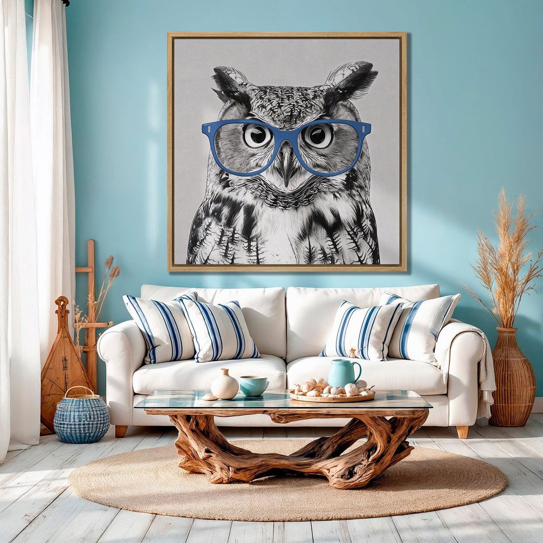 Framed Wall Art: Whimsical owl portrait in black & white with blue glasses, displayed in a coastal-themed interior with a blue & neutral color palette. Perfect wall decor!