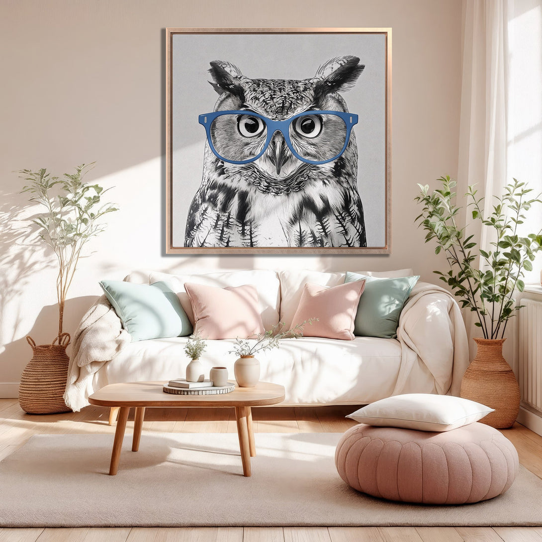 Framed Wall Art: Playful owl portrait in a modern interior. Black & white artwork with blue glasses, complemented by a soft, neutral color palette.