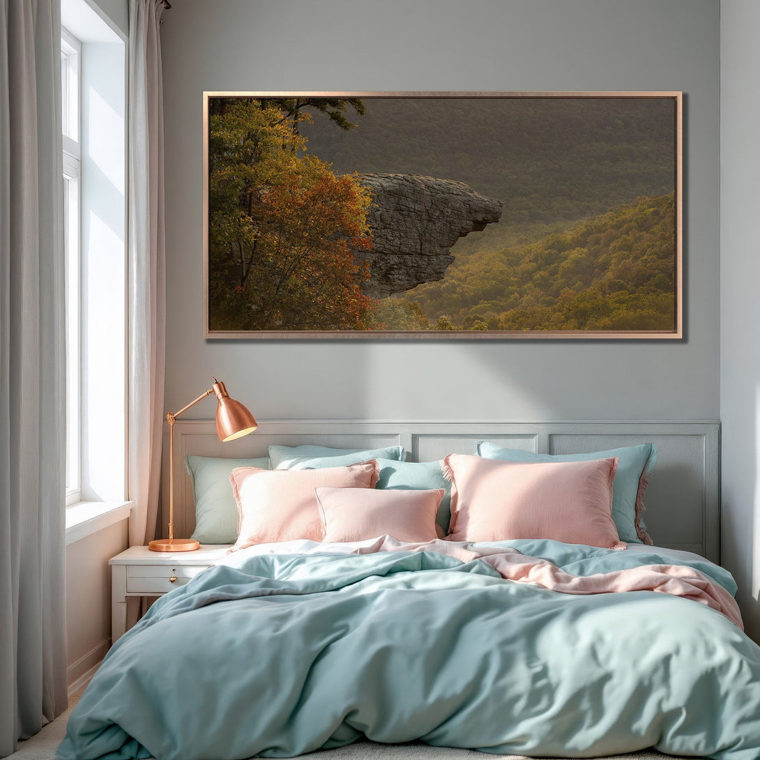 Framed Wall Art: Landscape Canvas Print with autumn forest and rock formation, warm color palette, displayed in a bedroom setting.