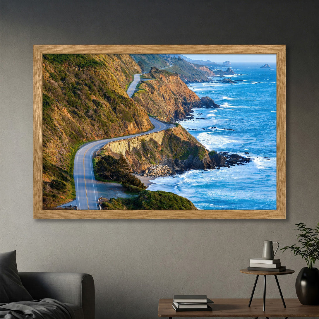 Framed Poster of scenic coastal highway. Landscape art with blue ocean, green cliffs, and warm tones. Perfect wall decor.