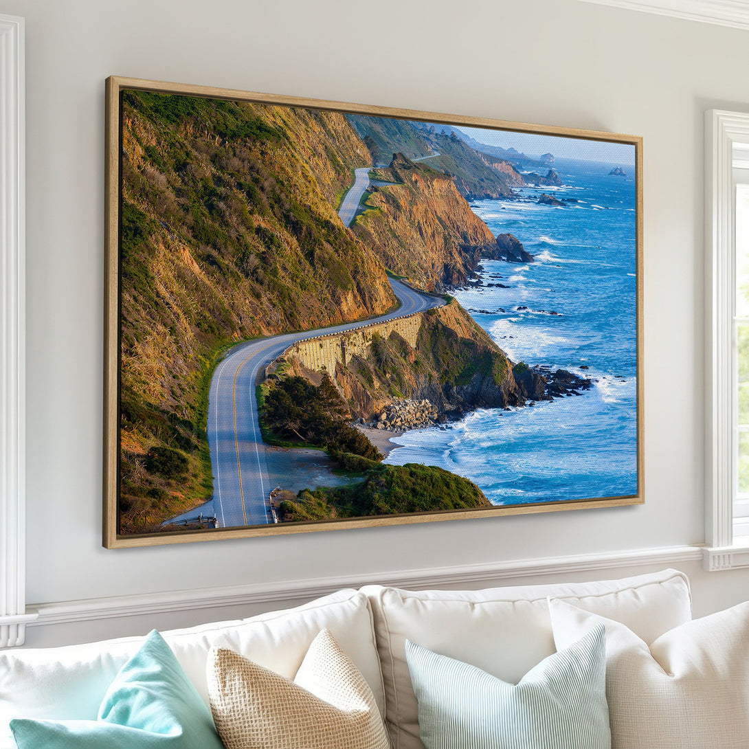 Framed Wall Art: Coastal highway canvas print. Capture the beauty of the Pacific Coast with this stunning art piece. Earthy tones & blue ocean create a serene vibe.