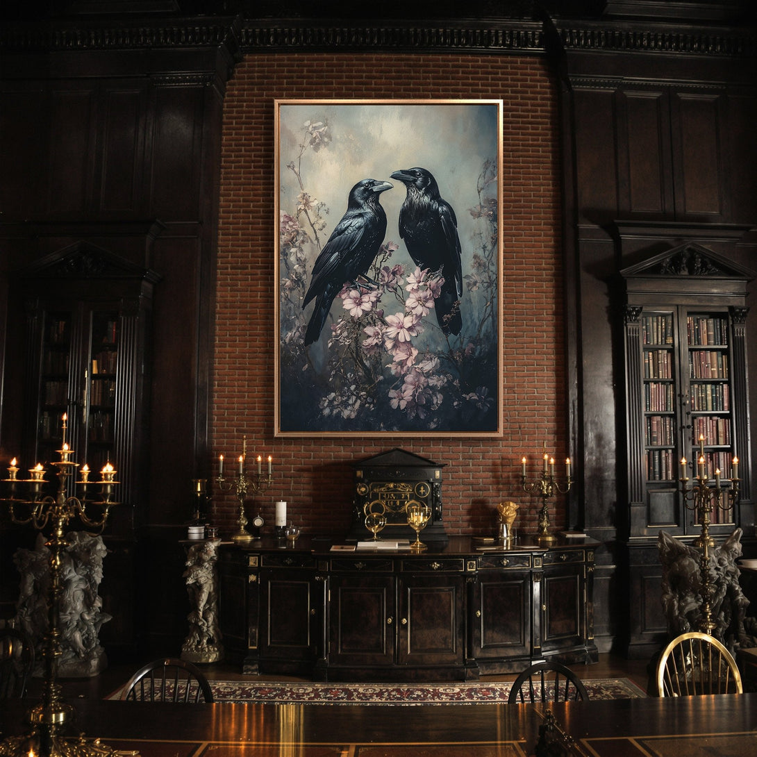 Framed Wall Art featuring two black ravens with pink flowers, displayed in a dark, gothic interior. Moody, artistic style with a muted color palette.