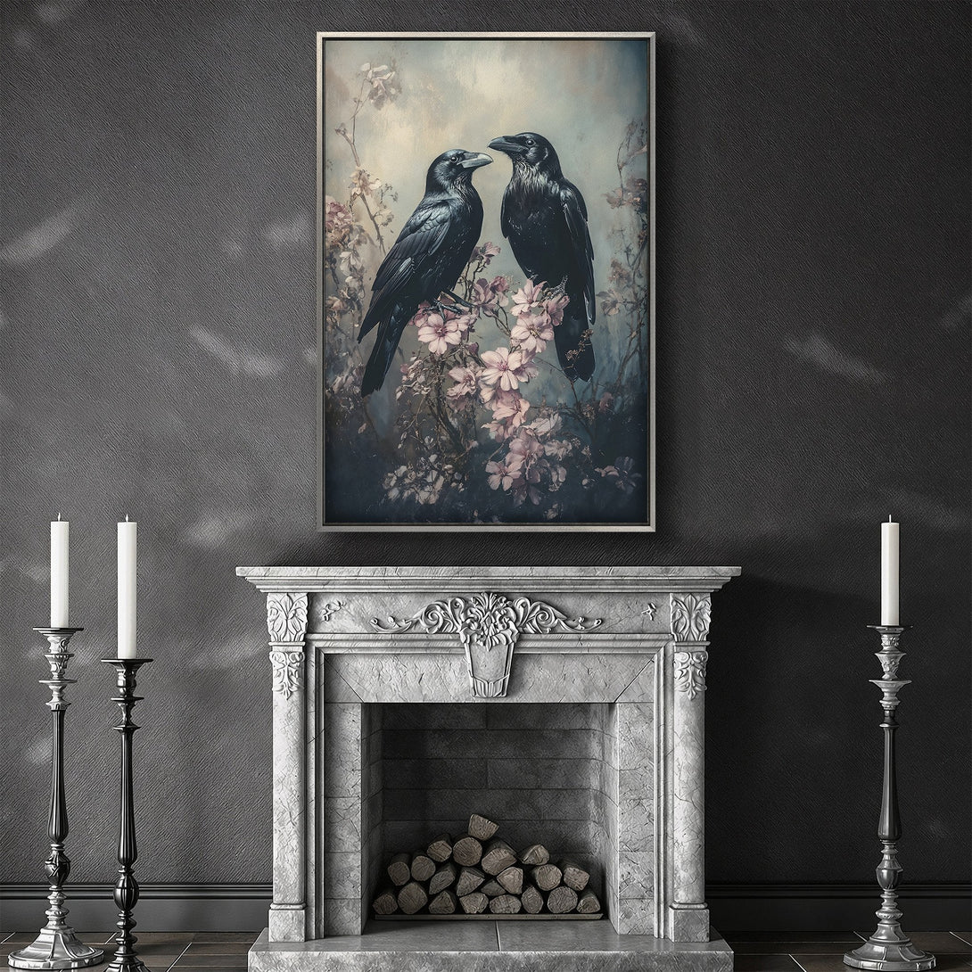 Framed Wall Art featuring two black ravens on a floral branch, in a moody, vintage style with a soft gray and pink color palette. Perfect for gothic home decor.