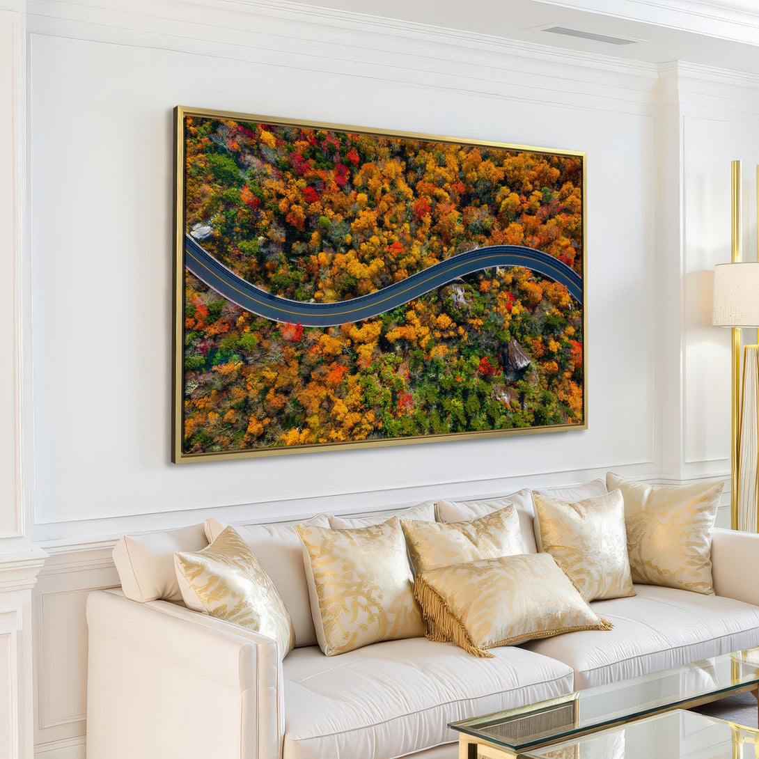 Canvas Print of a winding road through vibrant autumn forest. Warm, natural color palette adds a touch of nature to any space.