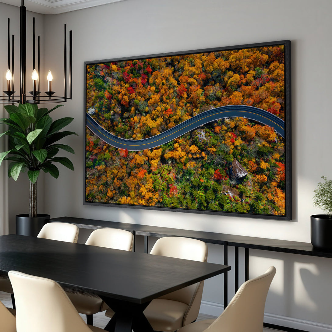 Framed Wall Art of a winding road through autumn foliage. Warm, vibrant colors of red, orange, and green. Enhance your space with this stunning canvas print!