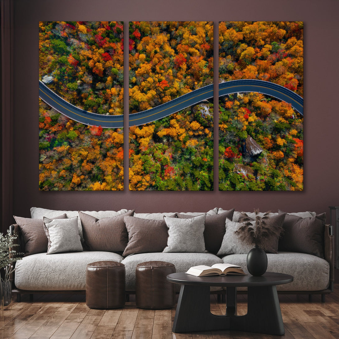 Canvas Print of a winding road through vibrant autumn foliage. Warm, inviting colors of orange, red, and green. Modern wall art.