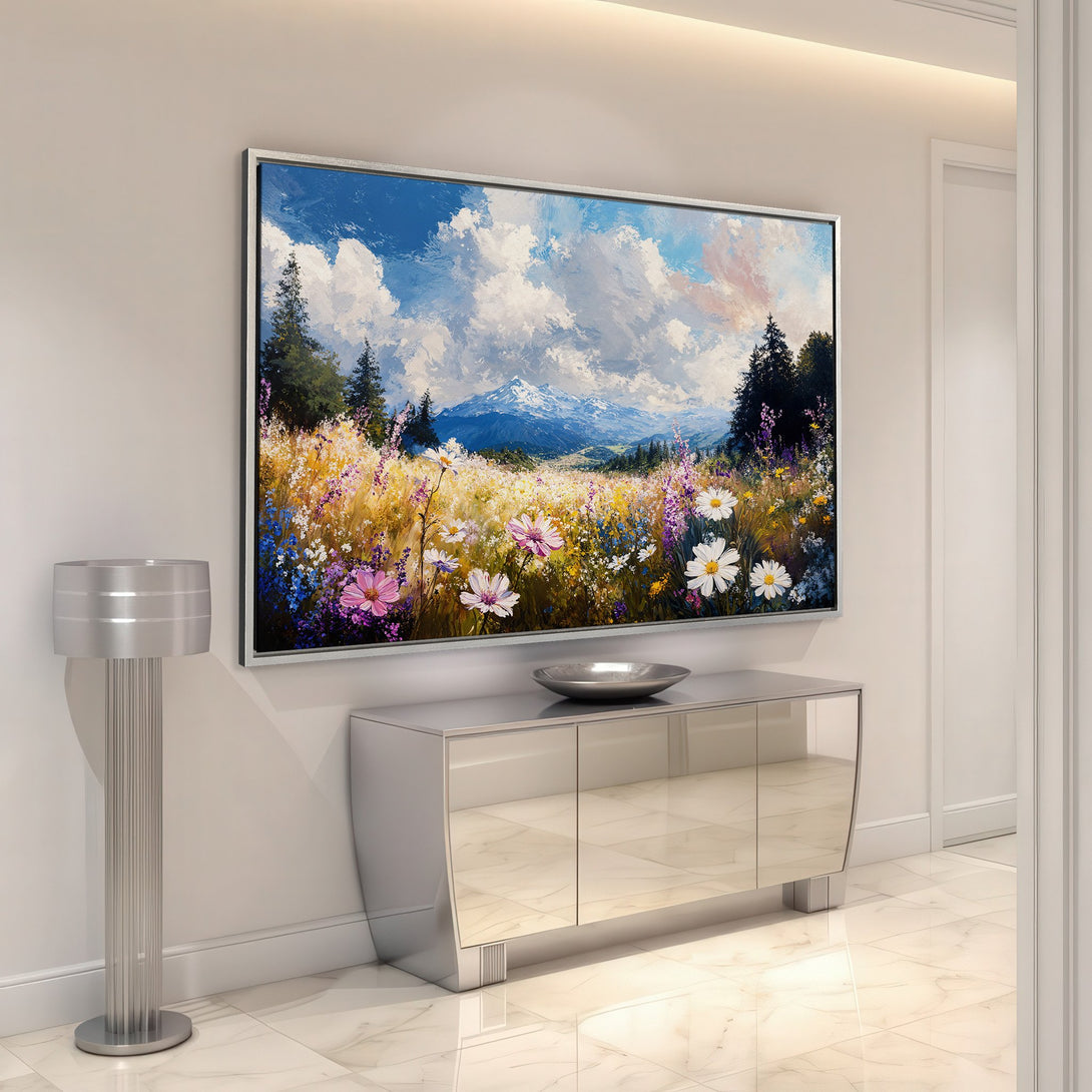 Framed Wall Art: Impressionist landscape canvas print with wildflowers and mountains in a blue, yellow, and pink color palette, perfect for home decor.
