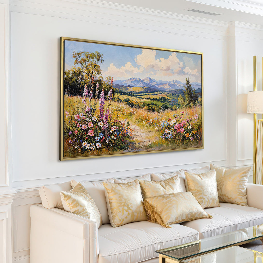 Canvas Print of a vibrant landscape painting in a living room. Features a colorful meadow with mountains, warm tones, and a touch of blue.
