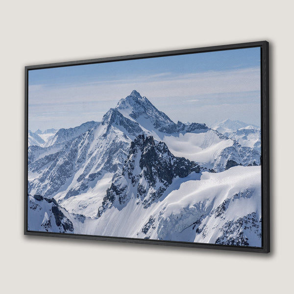 Framed Wall Art: Majestic mountain landscape Canvas Print. Stunning snowy peaks with blue sky, perfect for adding a touch of nature's beauty to your home decor.