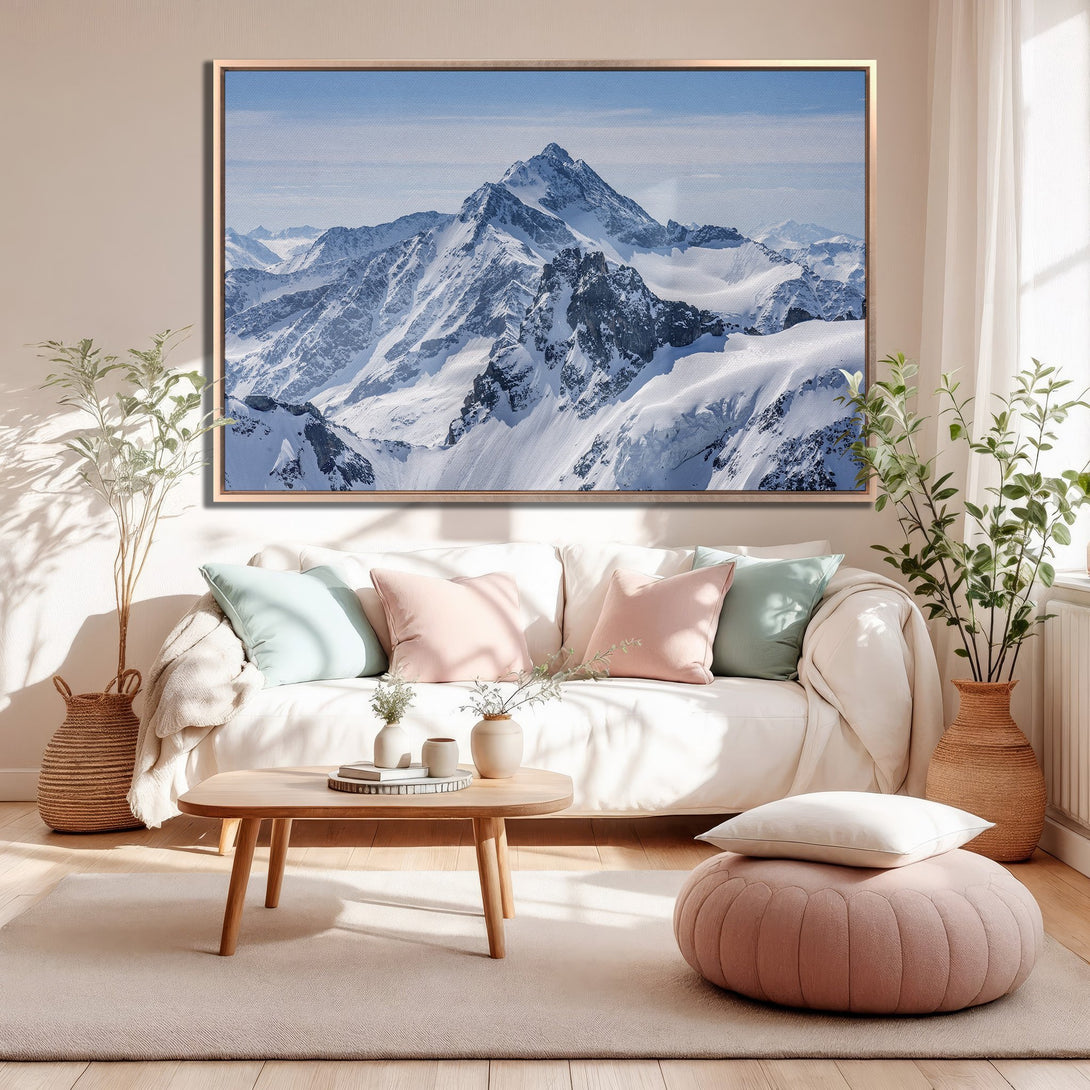 Framed Wall Art of snowy mountain landscape in a cozy living room. Neutral color palette with pops of pink and blue. Bring the outdoors in!