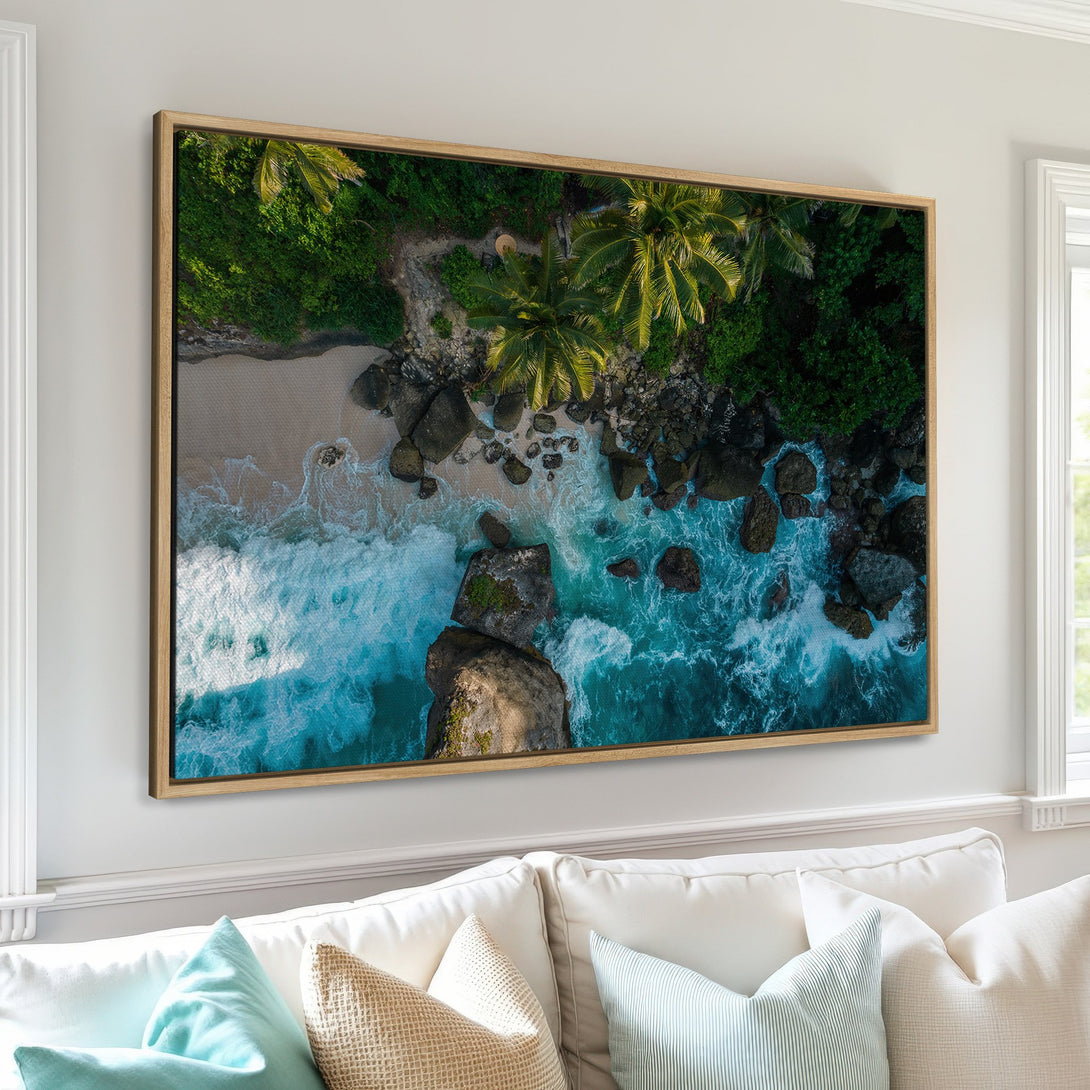 Framed Wall Art featuring a stunning aerial view of a tropical beach with turquoise water and lush green foliage. Coastal decor with a serene, natural color palette.