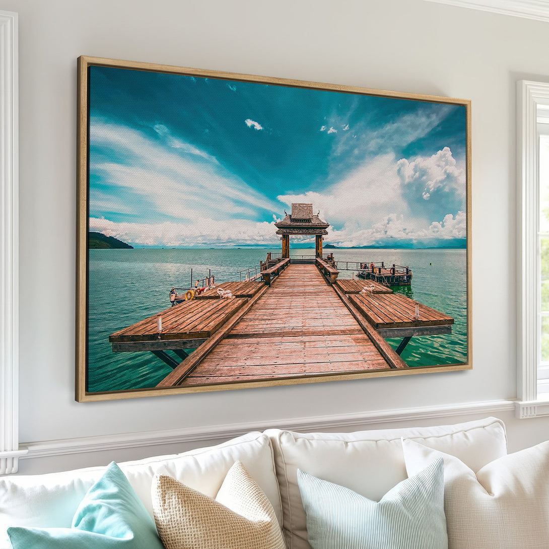Framed Wall Art featuring a serene pier scene with a blue and teal color palette. Bring the tranquility of the ocean to your home with this stunning Canvas Print.