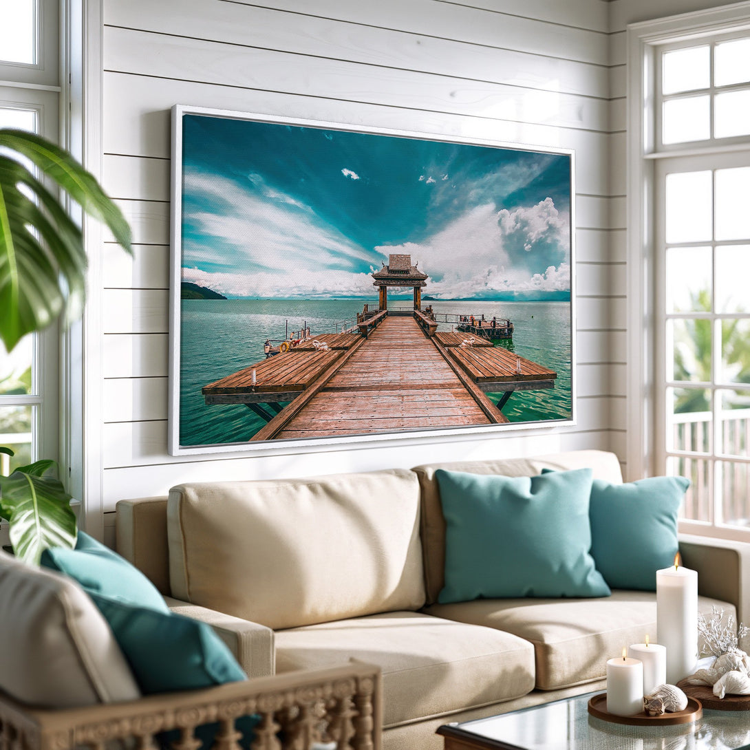 Framed Wall Art: Coastal pier scene in teal and brown tones. Canvas print adds a touch of serenity to any space. Perfect for beach house decor.